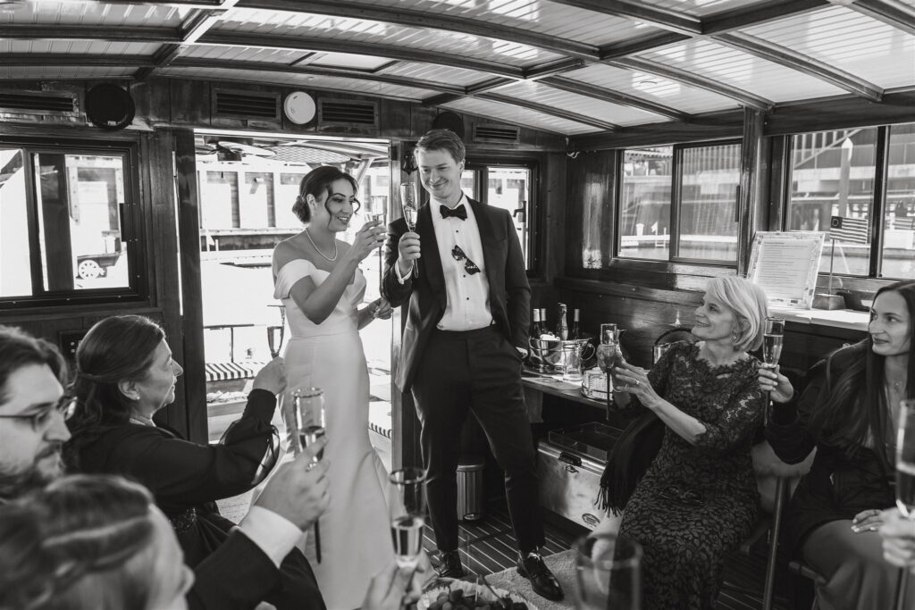 elegant elopement couple celebrating with guests on yacht on the potomac in washington dc