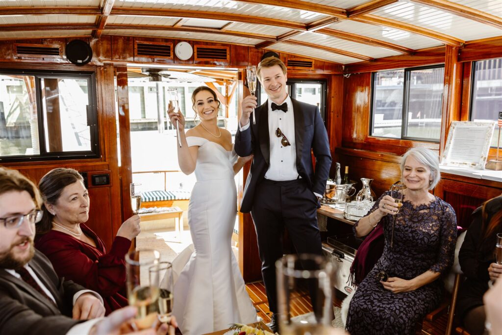 elegant elopement couple celebrating with guests on yacht on the potomac in washington dc