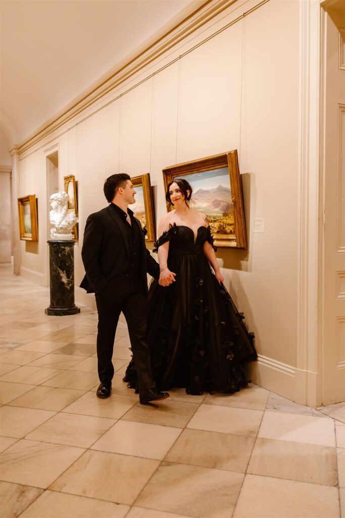 bride and groom in front of paintings at the national portrait gallery 
