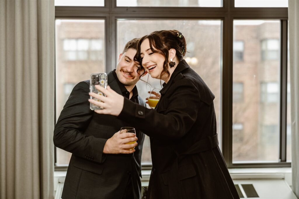 bride and groom having fun at the hotel as they are getting ready for their elopement