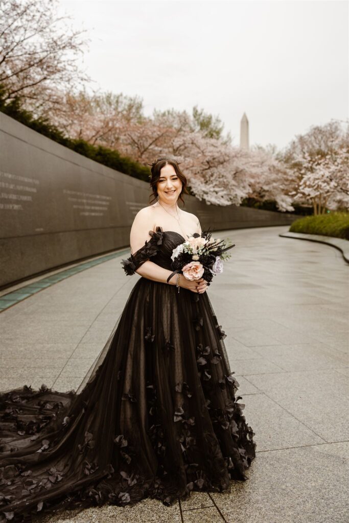 bride in a black wedding dress in washington dc during cherry blossom season at tidal basin