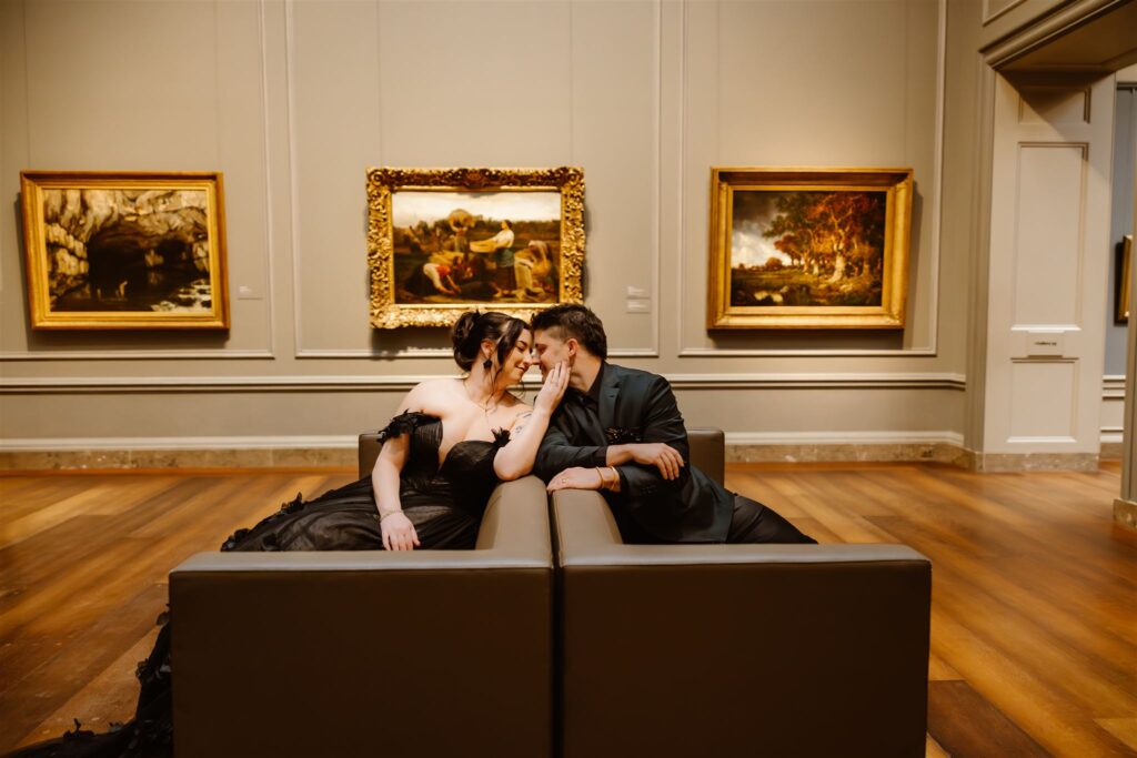 gothic elopement couple sitting on the sofa during their dc elopement at the national gallery of art