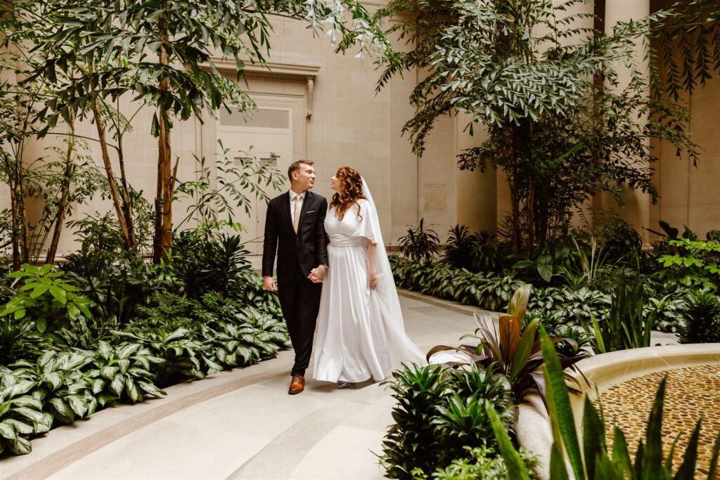 bride and groom exploring the national gallery of art during their two day elopement adventure