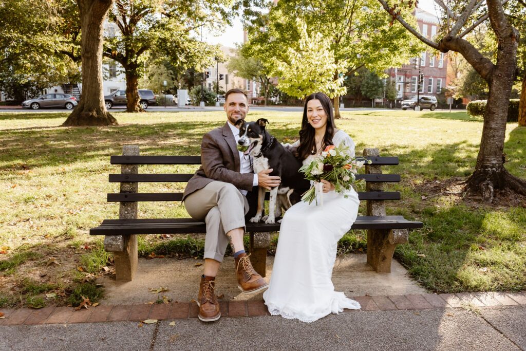 bride and groom posing with their pup