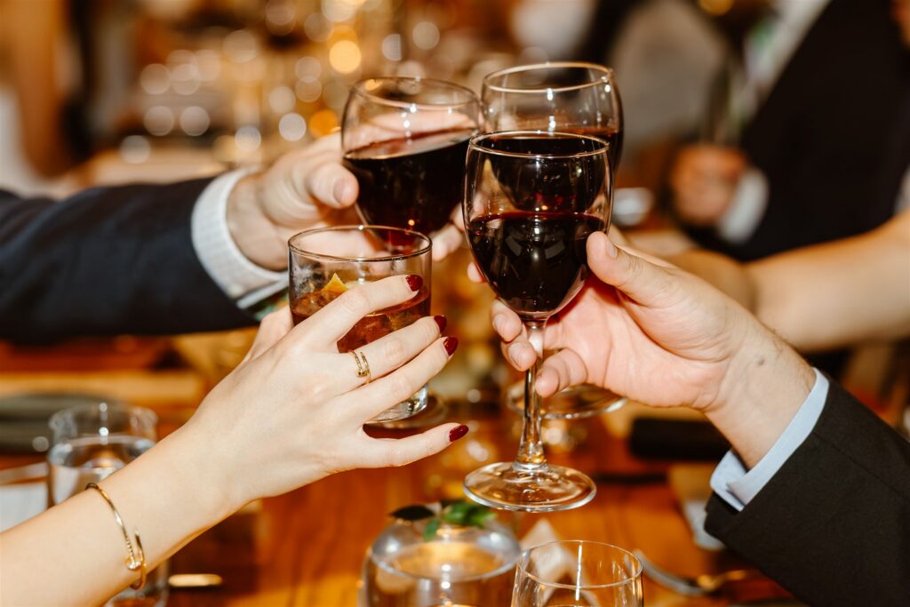 people toasting with cocktails and wine