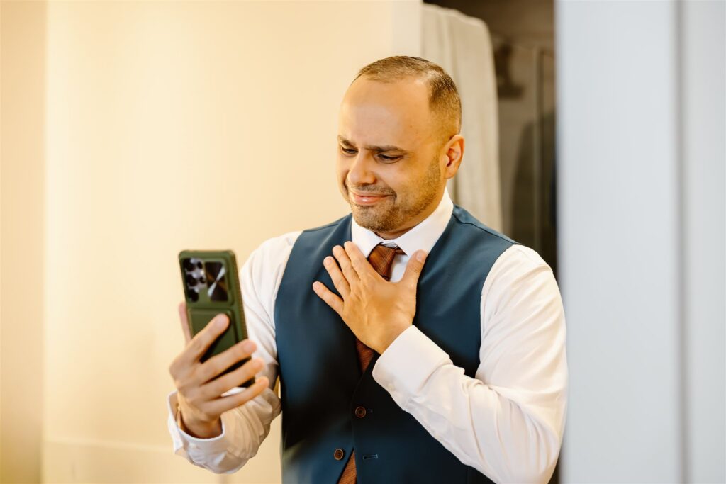 groom facetiming his family while getting ready