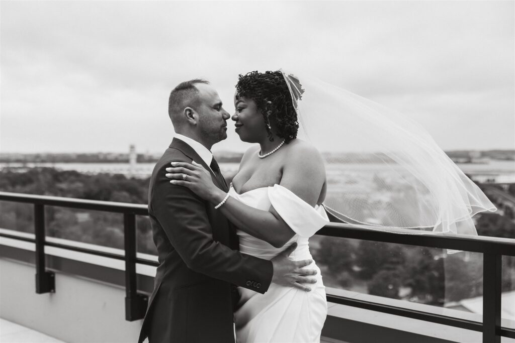 bride and groom almost kissing on a rooftop of their apartment building