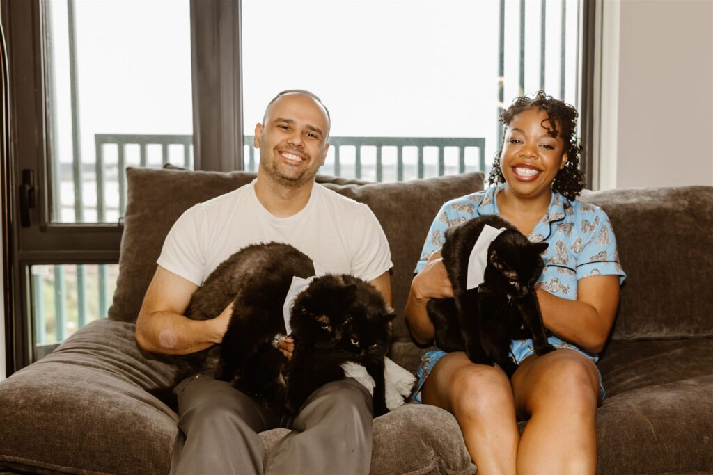 elopement couple smiling and holding their pet cats