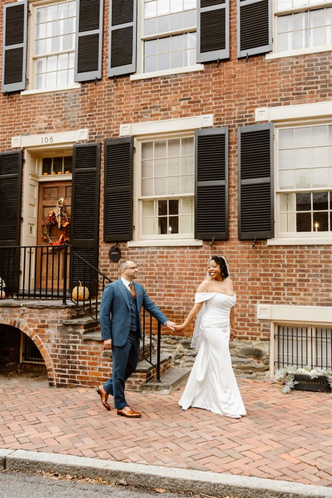 bride and groom having fun and exploring the cobblestone streets of Old Town Alexandria