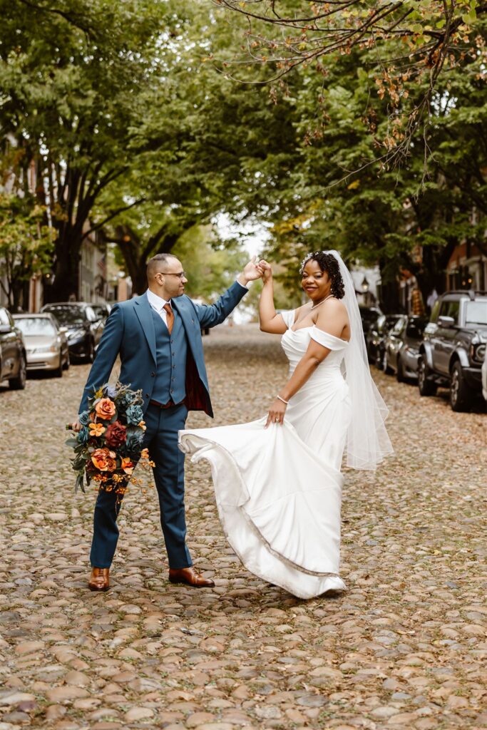 bride and groom having fun and exploring the cobblestone streets of Old Town Alexandria