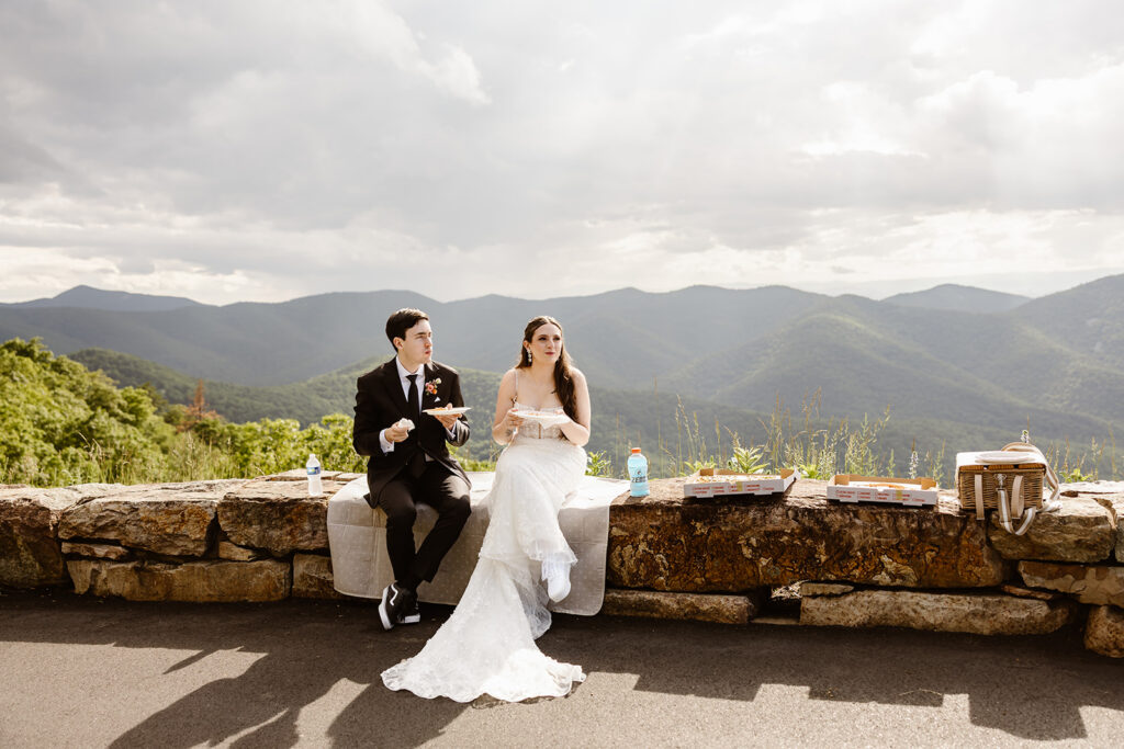 elopement couple enjoying pizza at a mountain overlook in shenandoah national park