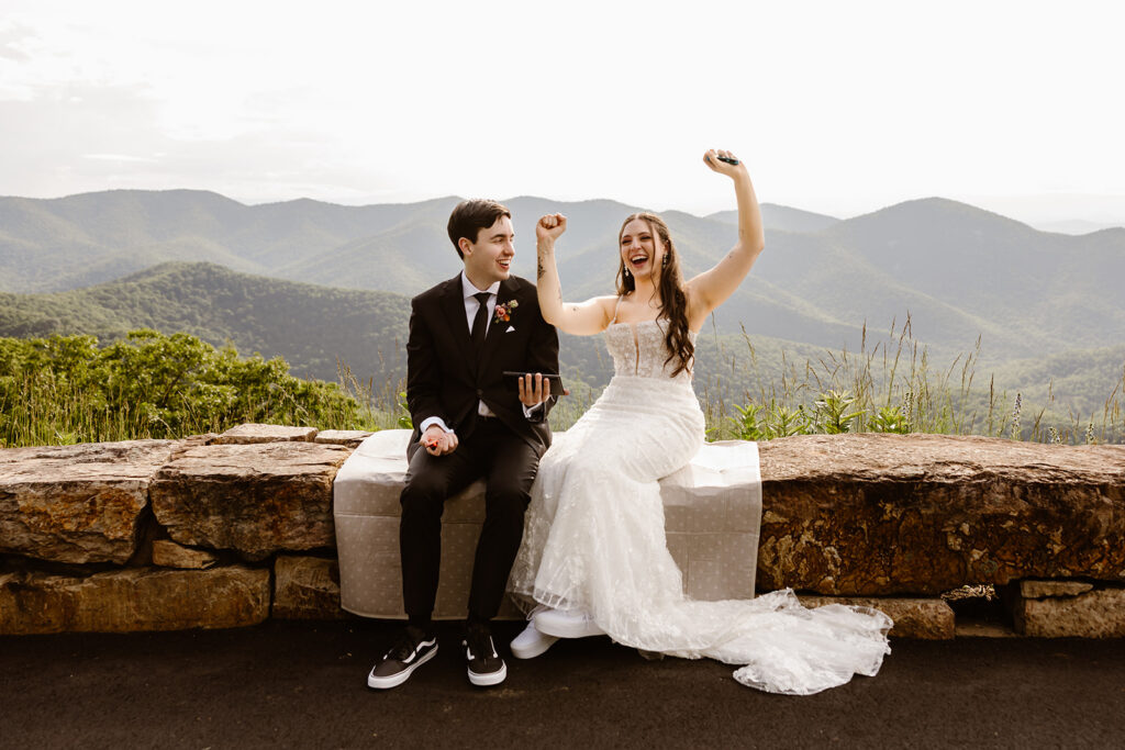elopement couple sitting at a mountain overlook in shenandoah national park