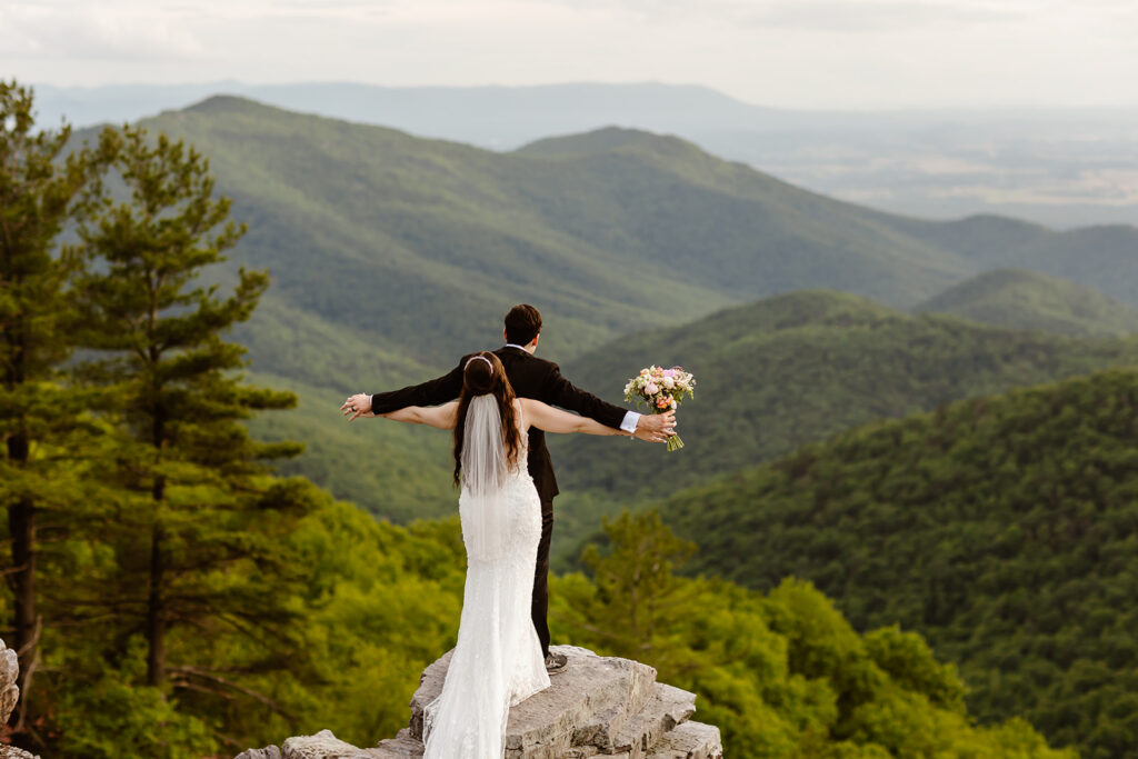 fun bride and groom moment at a mountain overlook in shenandoah national park