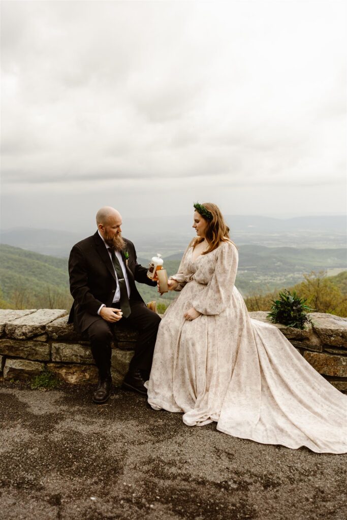 bride and groom drinking mead at a mountain overlook in shenandoah national park