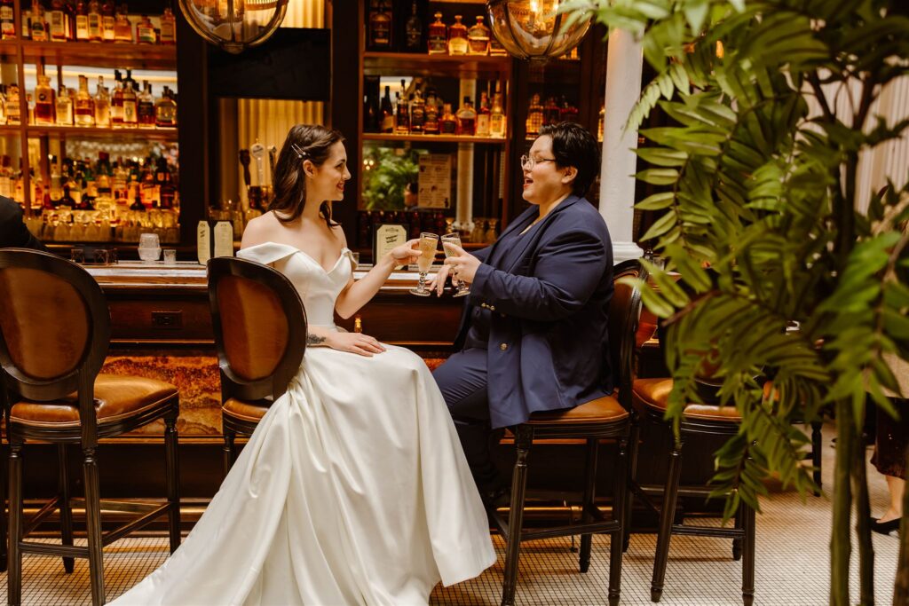 queer elopement couple enjoying drinks together
