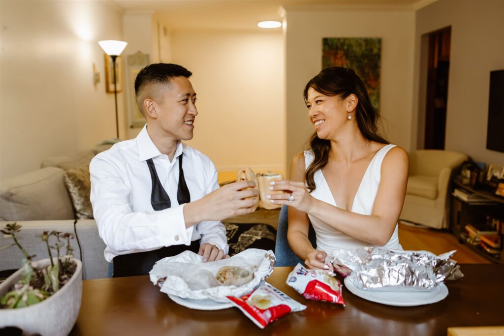 playful elopement couple enjoying some food at their condo