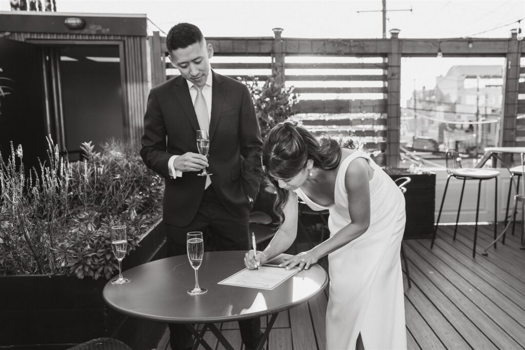 elopement couple signing their marriage license