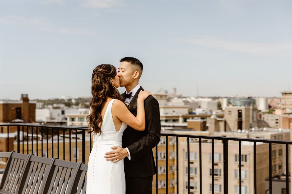 bride and groom kissing on a rooftop in washington, dc