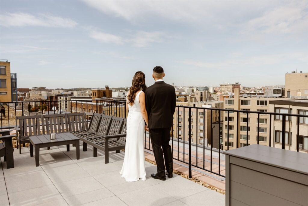 bride and groom holding hands on a rooftop in washington, dc