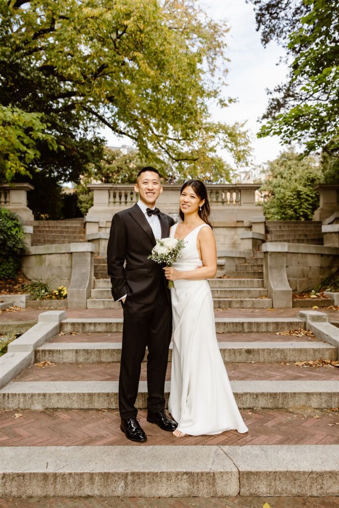 bride and groom posing on the spanish steps in washington dc