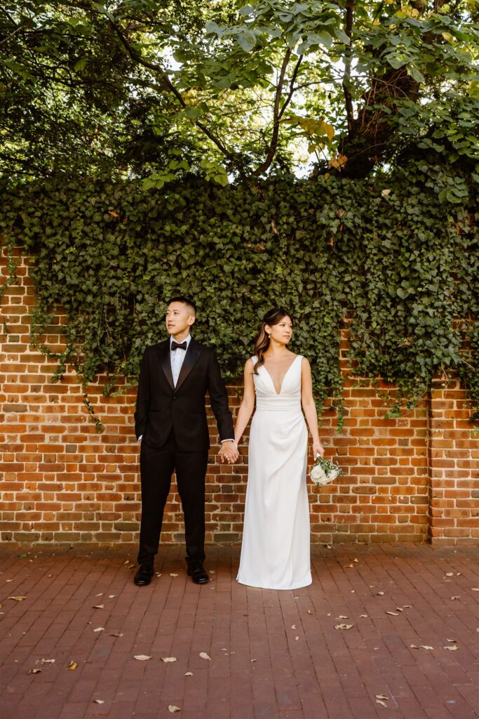playful bride and groom wandering the cobblestone streets of georgetown, dc