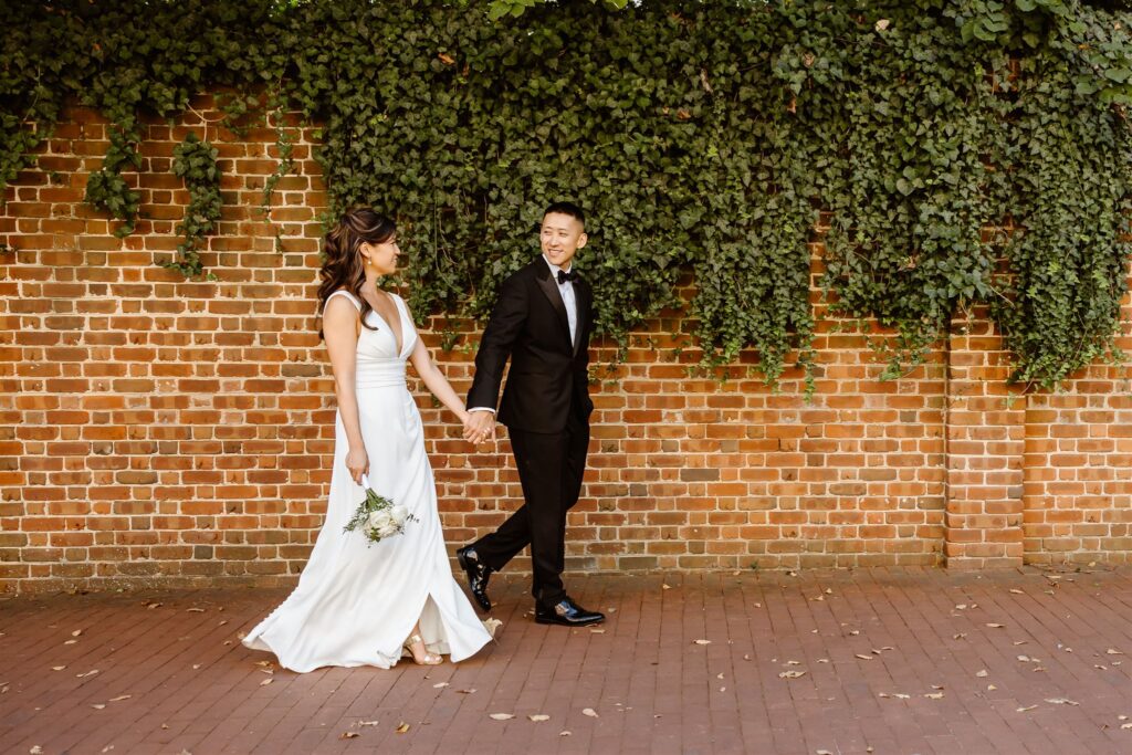 playful bride and groom wandering the cobblestone streets of georgetown, dc