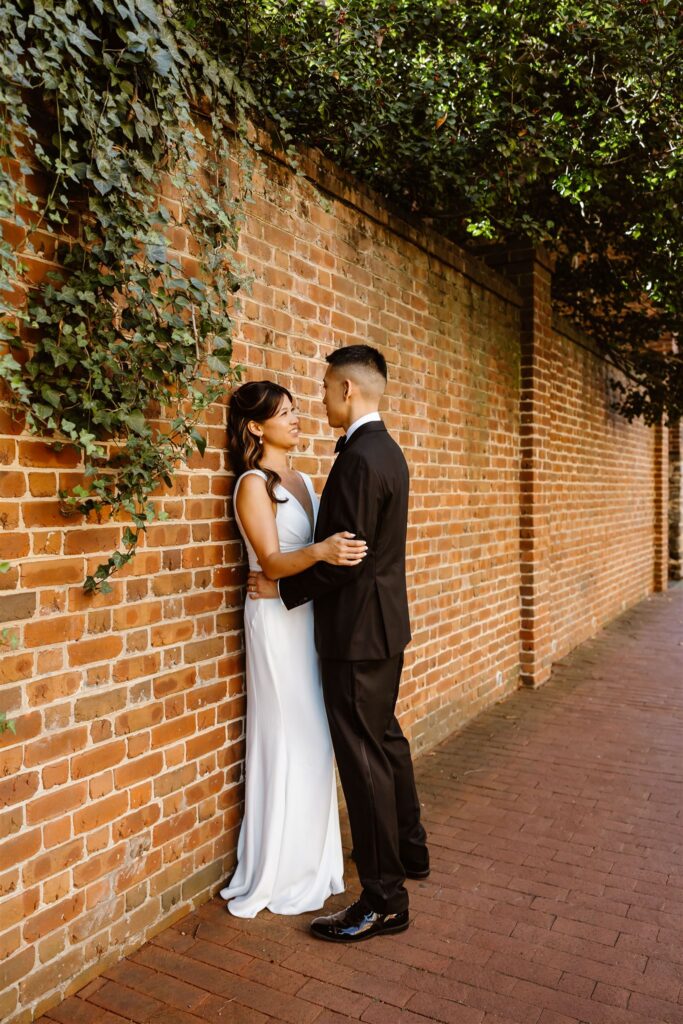 playful bride and groom wandering the cobblestone streets of georgetown, dc