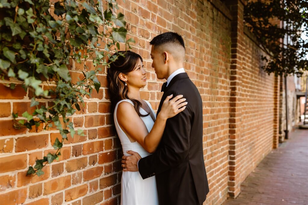 playful bride and groom wandering the cobblestone streets of georgetown, dc