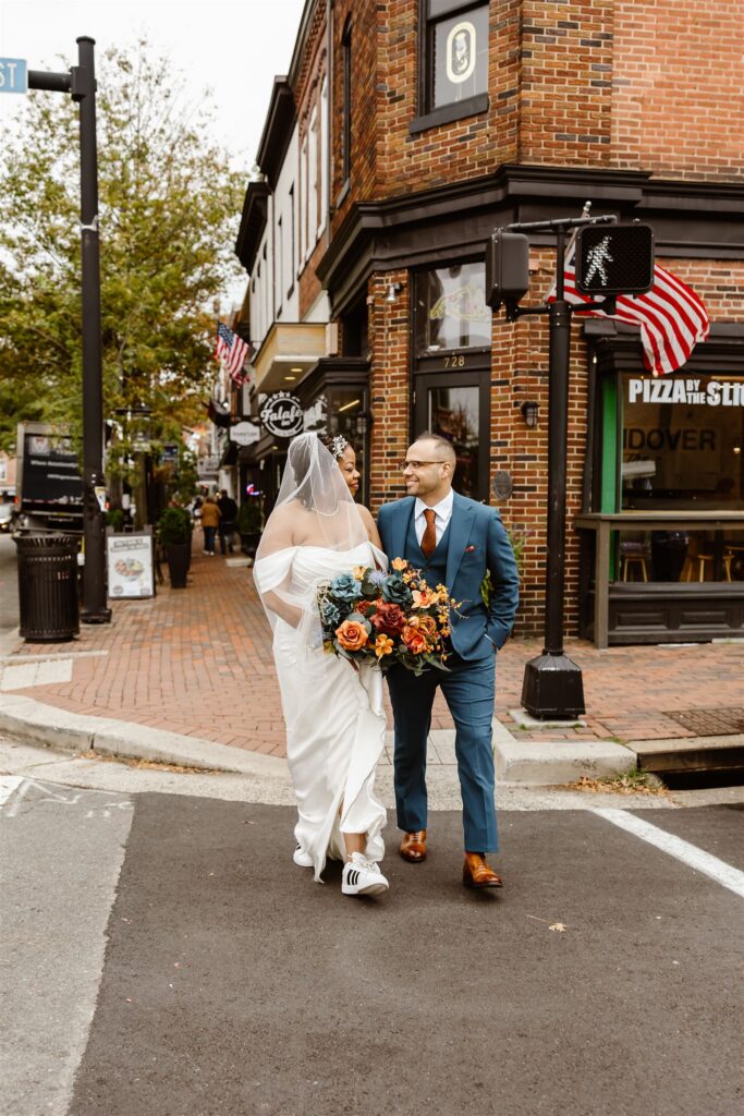 fun bride and groom moment wandering cozy streets during their elopement