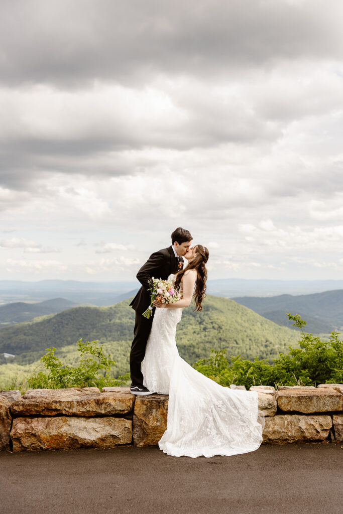 bride and groom kissing at a mountain overlook during their shenandoah national park elopement