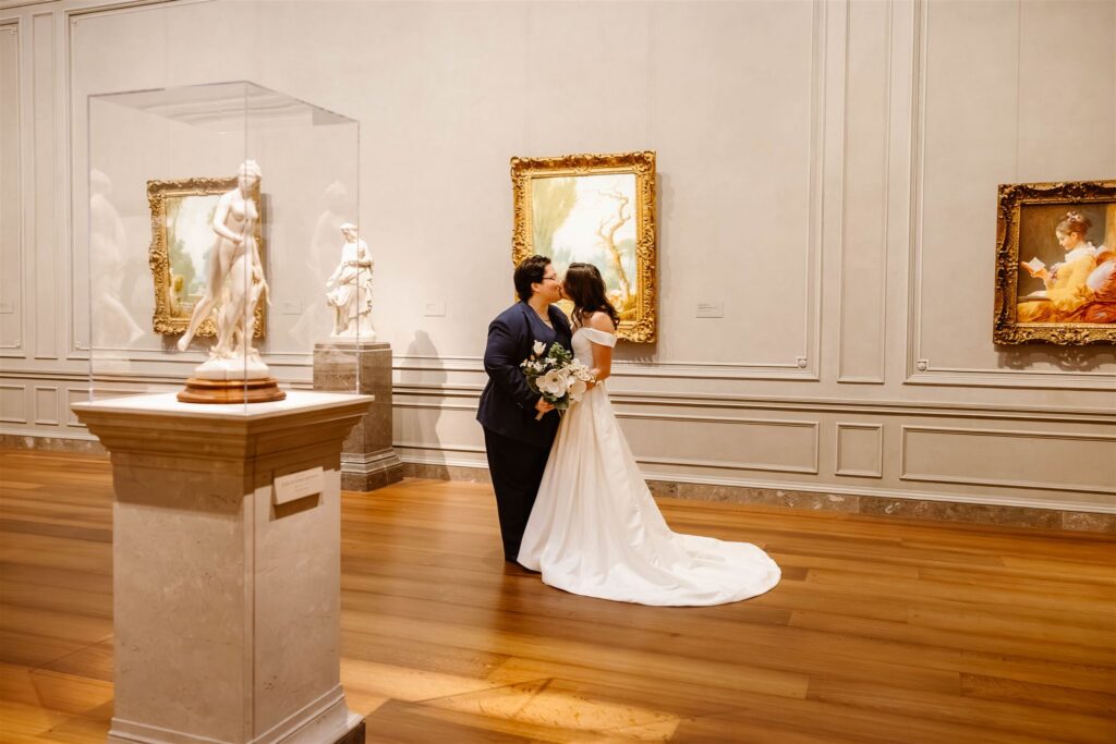 the elopement couple embracing by the art in the National Gallery of Art
