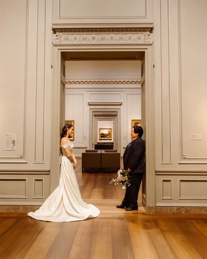 the elopement couple leaning against the door frame in an art exhibit at the National Gallery of Art