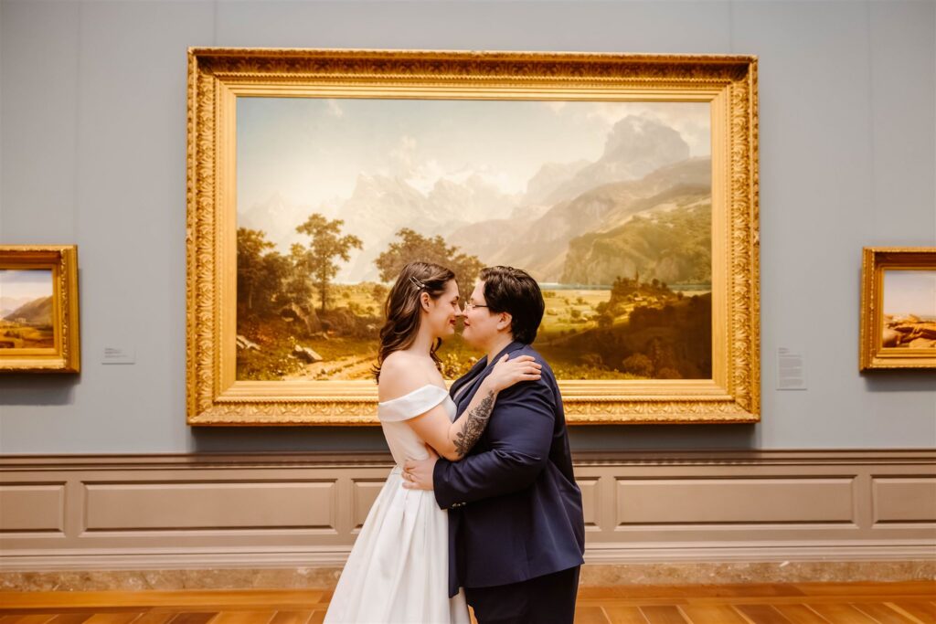 the elopement couple embracing by the art in the National Gallery of Art