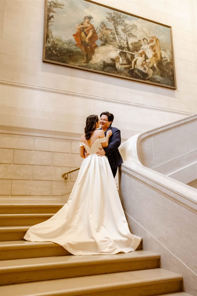 the wedding couple kissing on the stairs at the National Gallery of Art