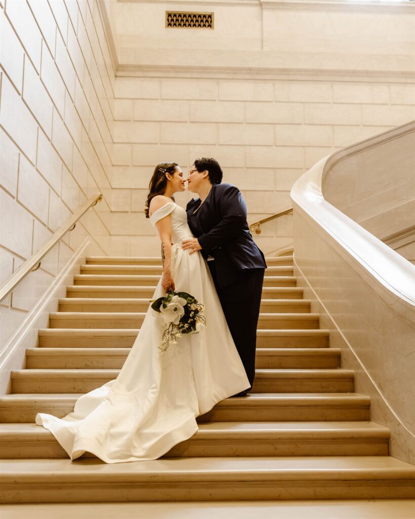the wedding couple kissing on the stairs at the National Gallery of Art