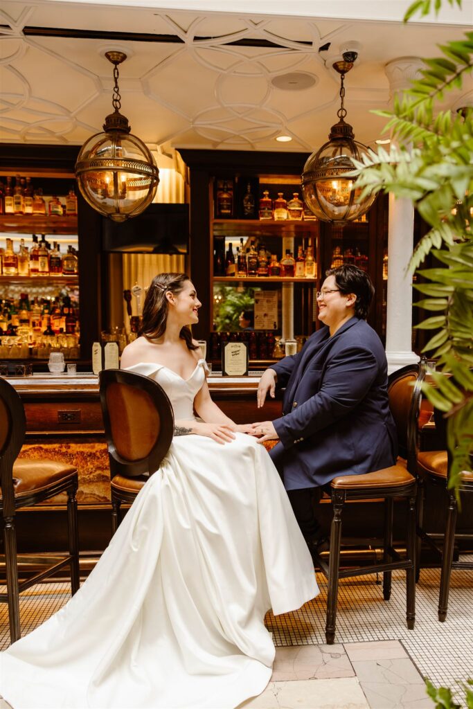 elopement couple sitting at a bar and enjoying their day