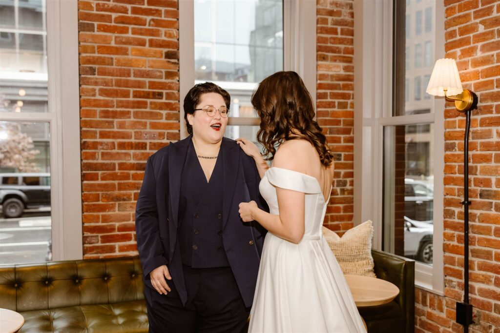 candid elopement couple first look at a hotel lobby