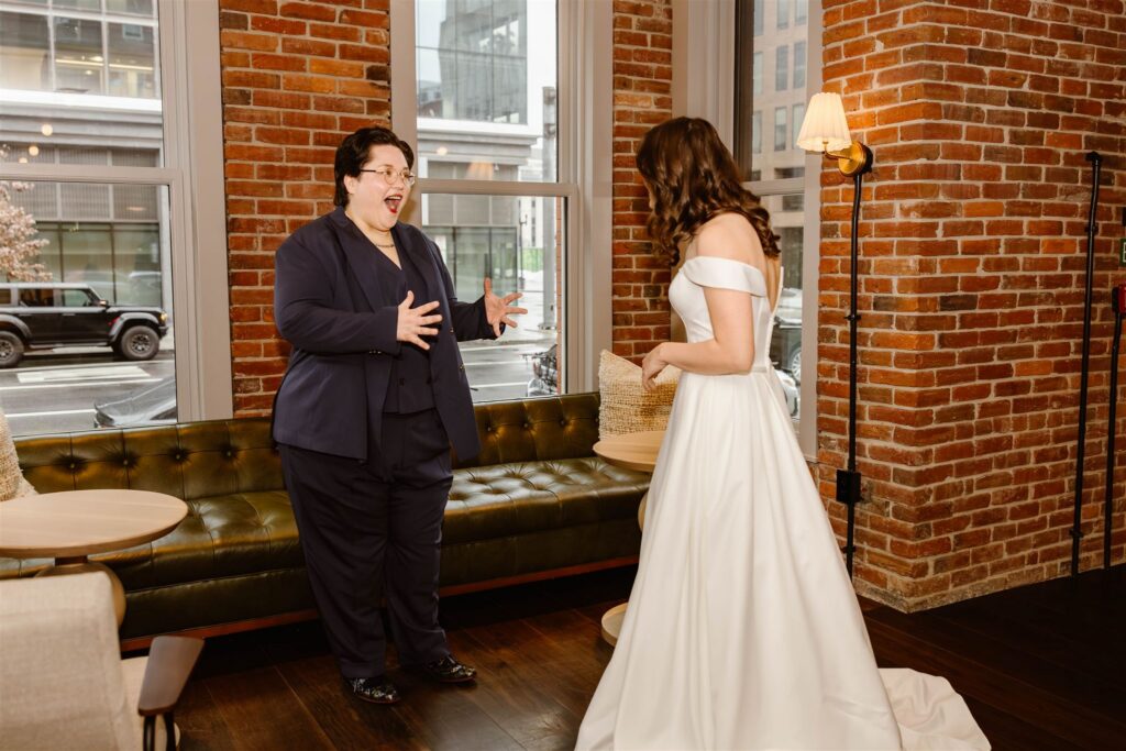 candid elopement couple first look at a hotel lobby