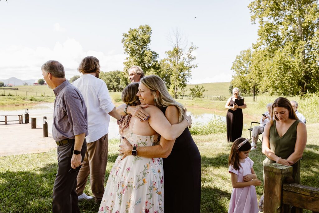 elopement couple hugging guests