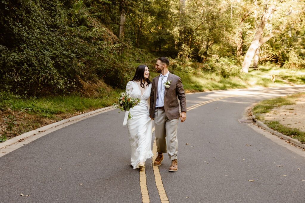 elopement couple posing on the road at the rock creek park