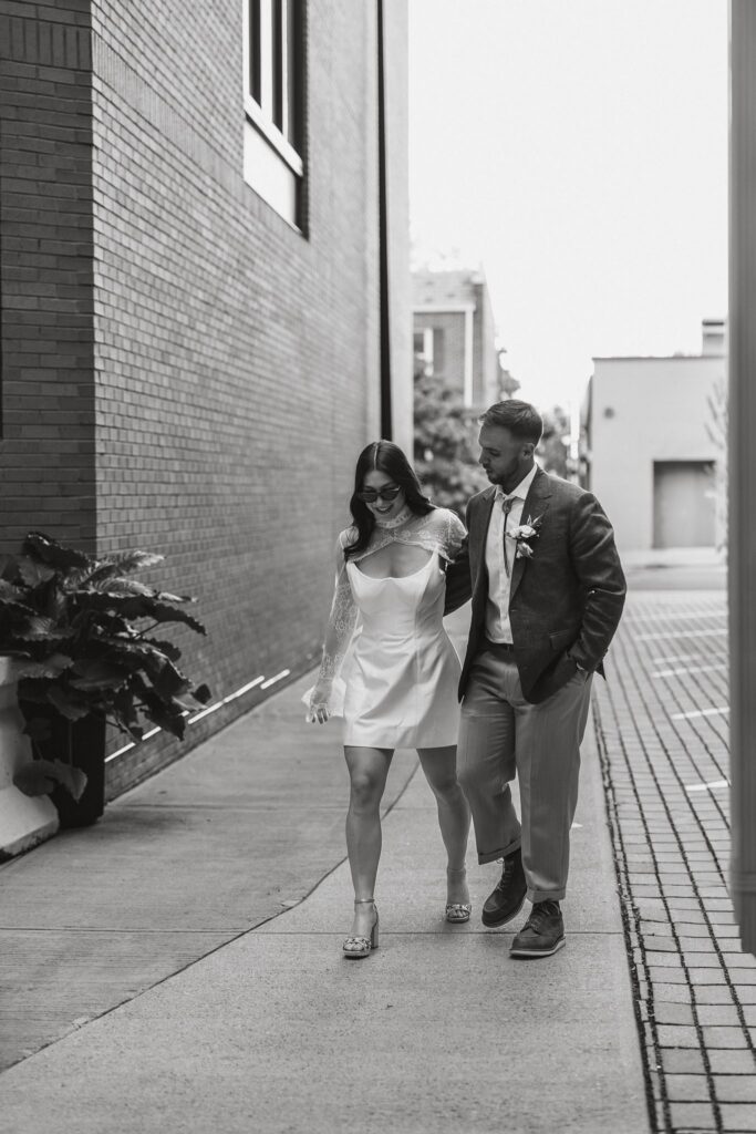 wedding couple walking to their pizza shop micro wedding reception