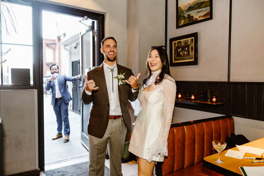 wedding couple arriving to their pizza shop micro wedding reception