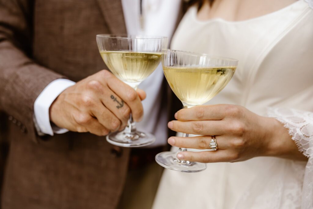 wedding couple holding champagne glasses