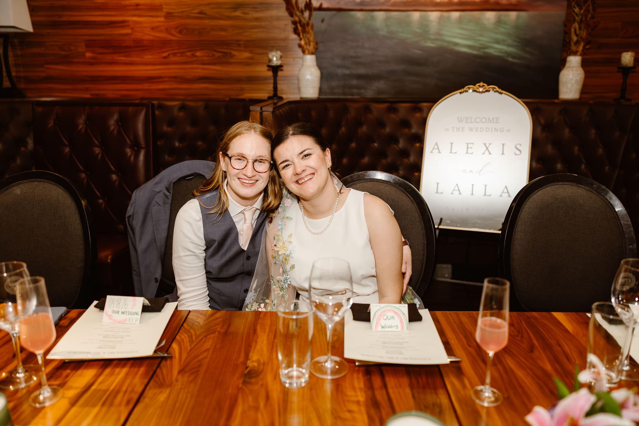 smiley brides during their old town alexandria micro wedding reception in a restaurant