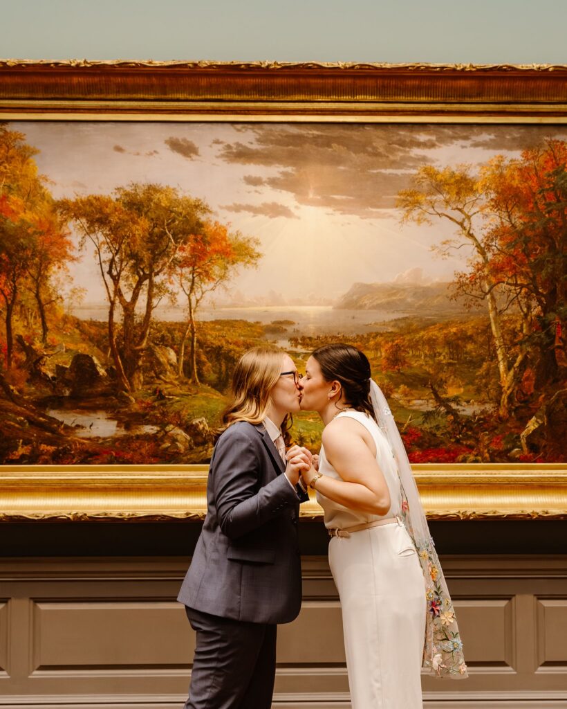 elopement couple kissing in front of artwork during their portraits at the national gallery of art in dc