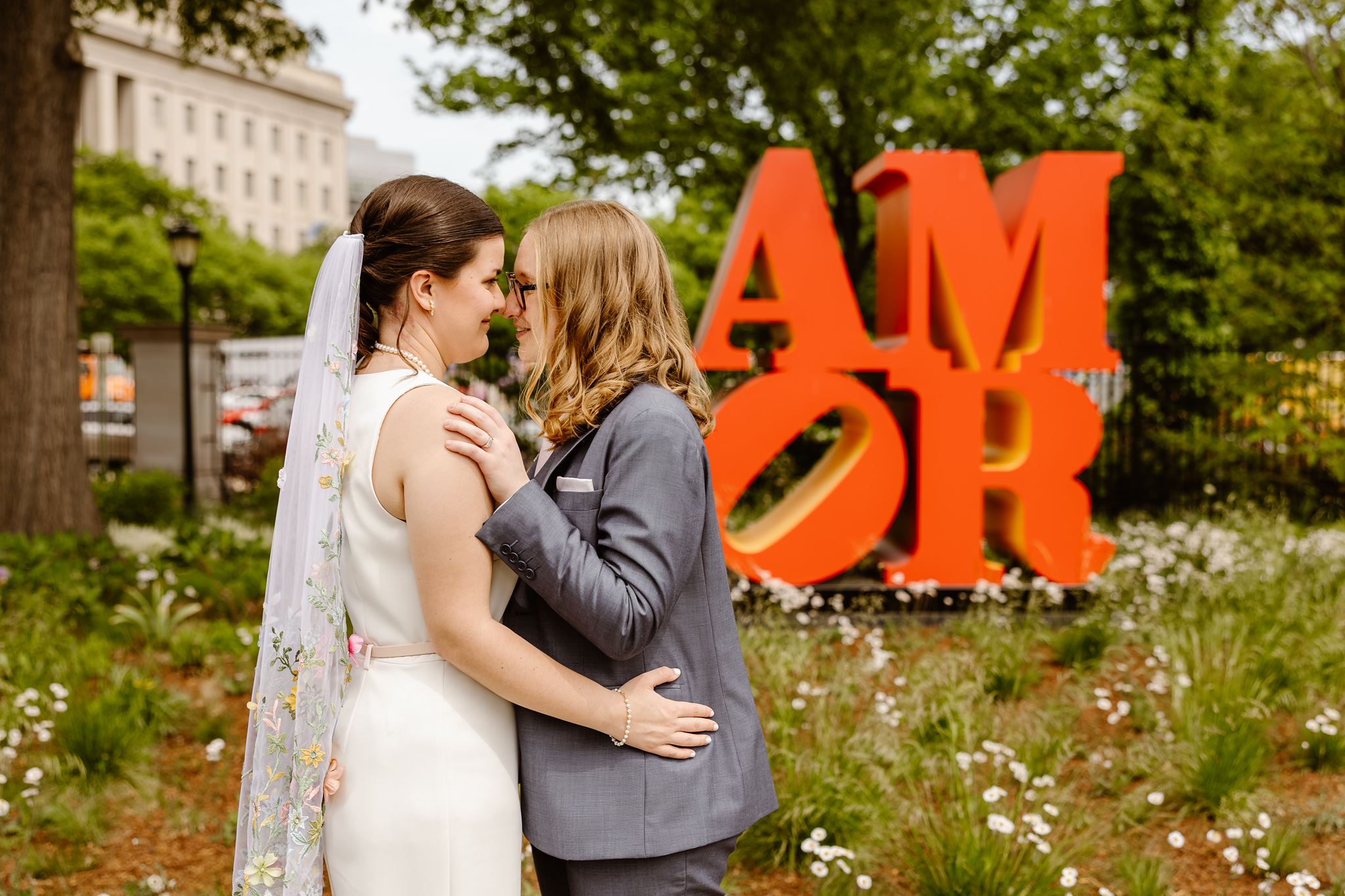 elopement couple in front of a sign that says AMOR during their DC elopement