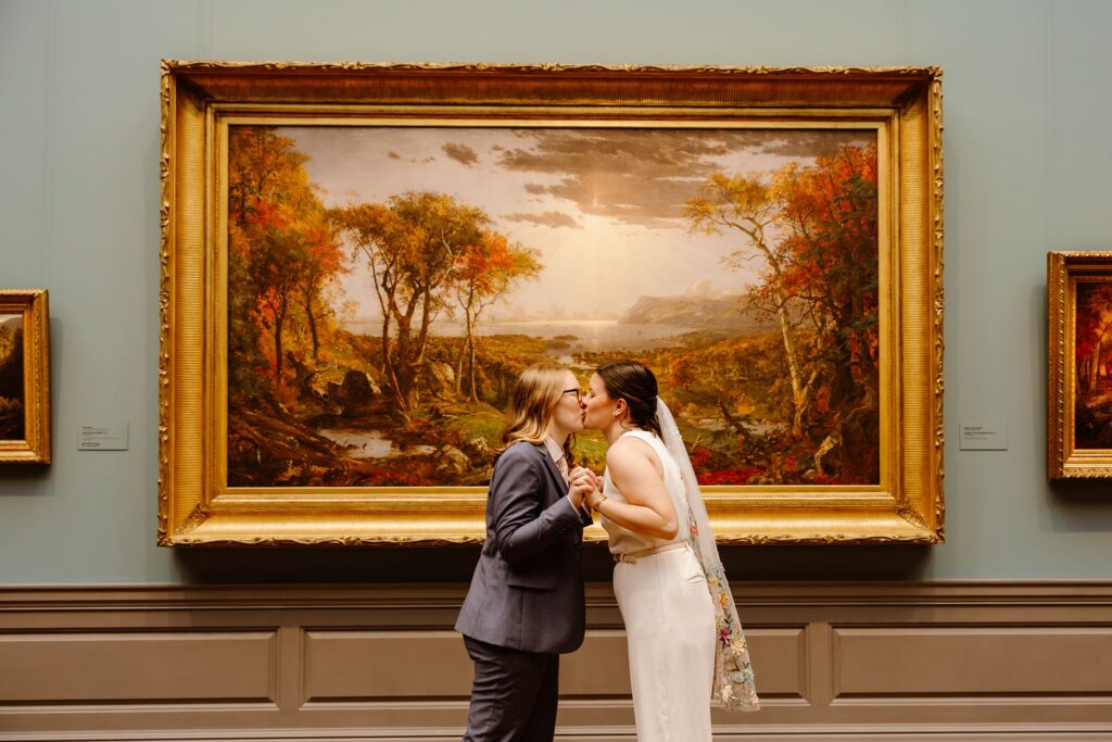 elopement couple kissing in front of artwork during their portraits at the national gallery of art in dc