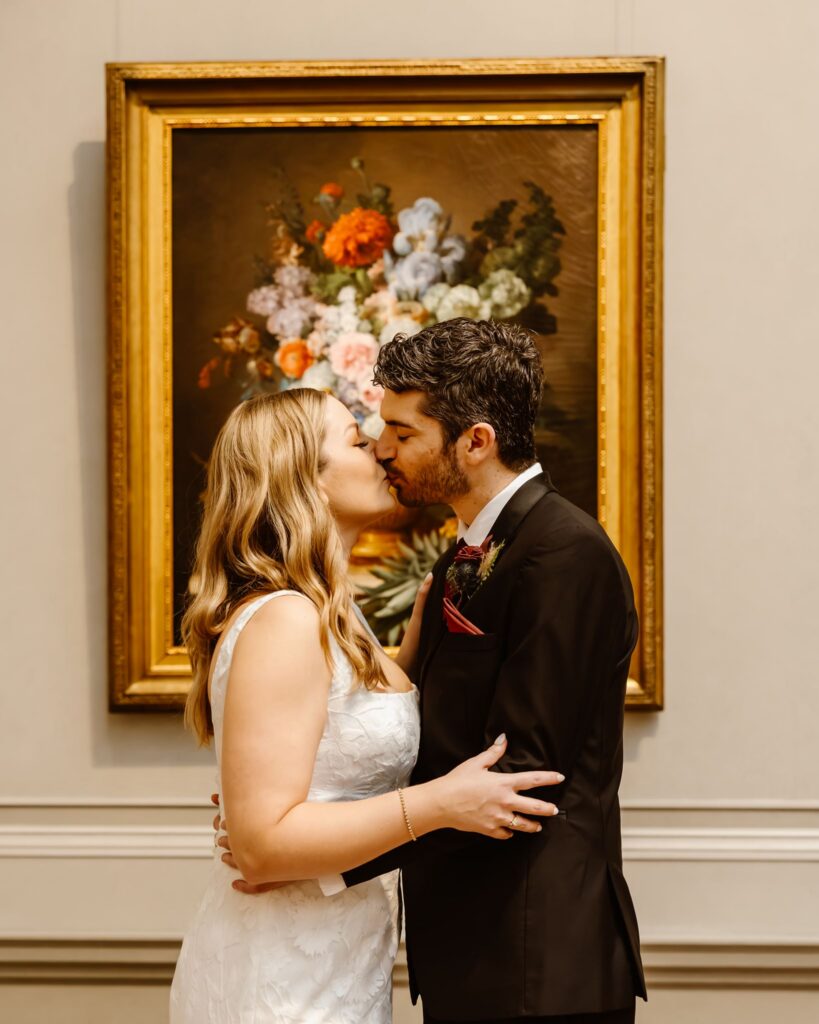 elopement couple kissing in front of artwork at the national gallery of art in dc