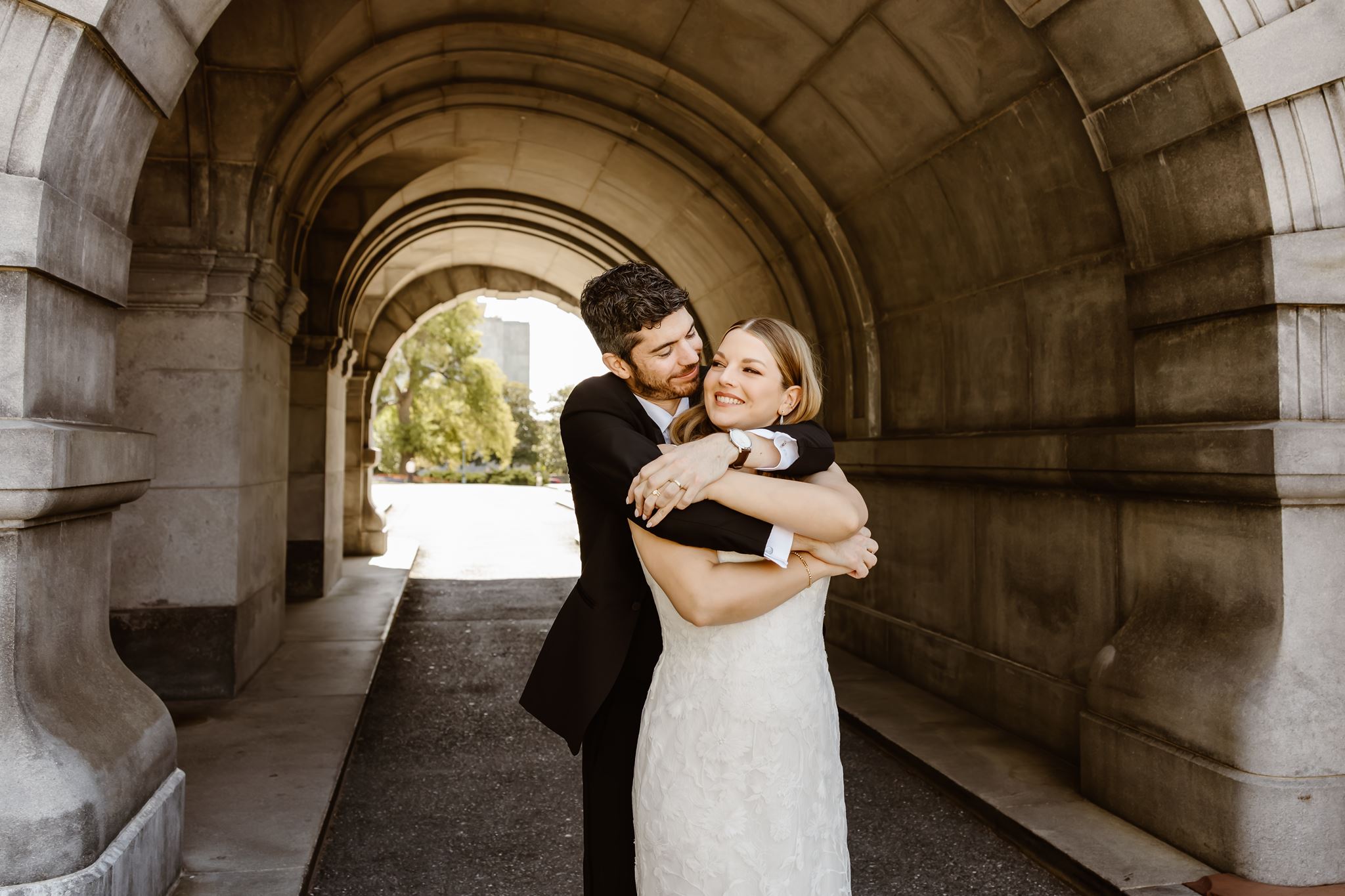 elopement couple hugging under a bridge