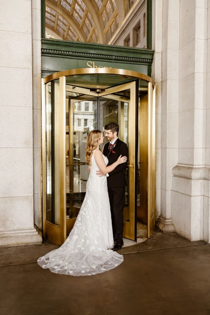 playful elopement couple at the revolving door of union station in washington dc